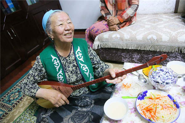 Jamalhan·Harbat performs Aken songs in her home in Emin county, Tacheng prefecture, Xinjiang Uygur autonomous region, May 24, 2016. (Photo by Gaoyuan Lingzi/provided to chinadaily.com.cn)
