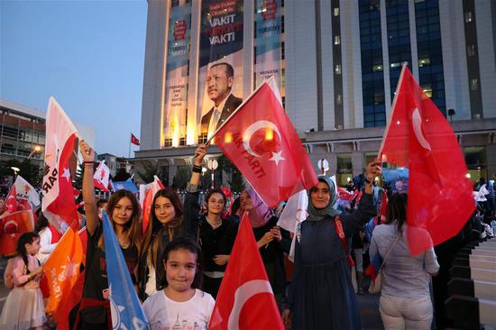 Supporters of Turkish President Recep Tayyip Erdogan rally in front of the Justice and Development Party (AKP) headquarters in Ankara, Turkey, on June 24, 2018.  (Xinhua/Mustafa Kaya)
