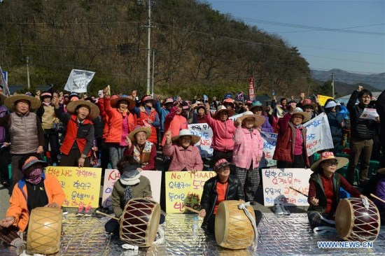 Protesters shout slogans during a rally near the golf course where the Terminal High Altitude Area Defense (THAAD) system will be deployed in Seongju, South Korea, March 15, 2017. About 200 local residents attended the rally on Wednesday to protest against the deployment of THAAD system. (Xinhua/Liu Yun)