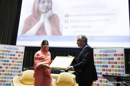 United Nations Secretary-General Antonio Guterres (R) designates Malala Yousafzai as the UN Messenger of Peace with a special focus on girls' education at the UN headquarters in New York, on April 10, 2017. (Xinhua/Li Muzi)